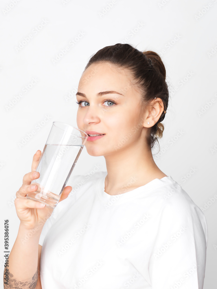 Young woman drinking a glass of clean water Young woman drinking a glass of clean water