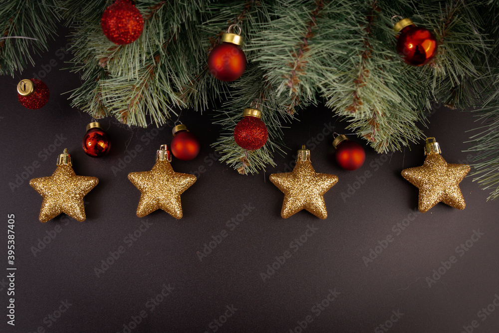 Christmas tree and elements gold star, red ball , green pine tree branched on dark background with copy space for creative graphic design, print , postcard, new year party invitation card and so on. Christmas tree and elements gold star, red ball , green pine tree branched on dark background with copy space for creative graphic design, print , postcard, new year party invitation card and so on.