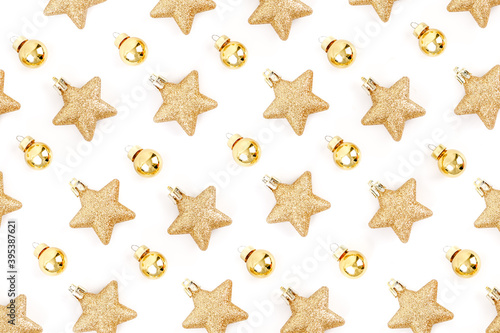 Top view of minimal golden and yellow Christmas elements pattern, stars glitter and ball on white background for make creative design and paper print gift wrapping.
