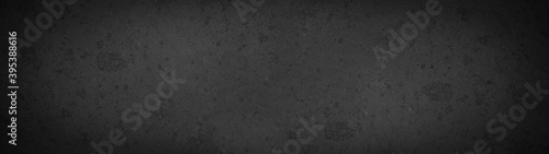 Black anthracite grunge stone concrete wall , blackboard, chalkboard texture wall background panorama banner 