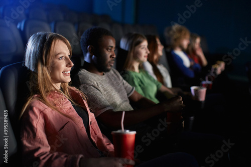 Young girl in cinema with friends.