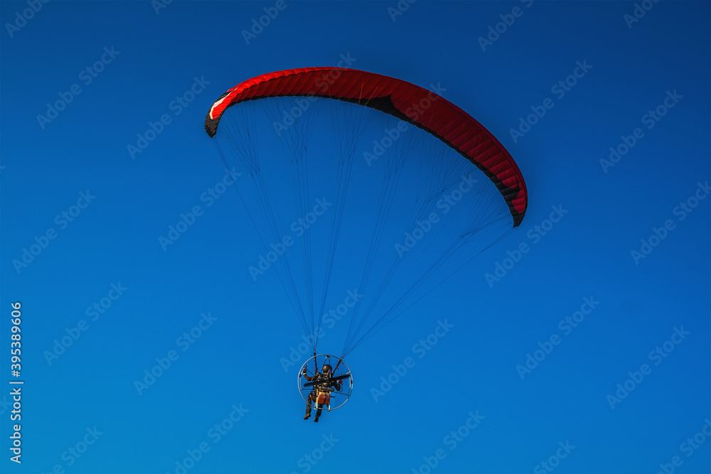 Paraglider in the air, beautiful blue sky in the background. Paraglider in the air, beautiful blue sky in the background.