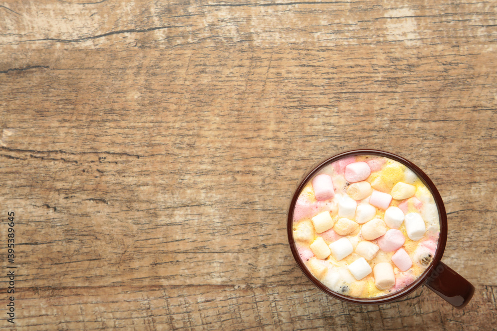 Hot cocoa drink with a marshmallows on grey wooden background. Hot cocoa drink with a marshmallows on grey wooden background.