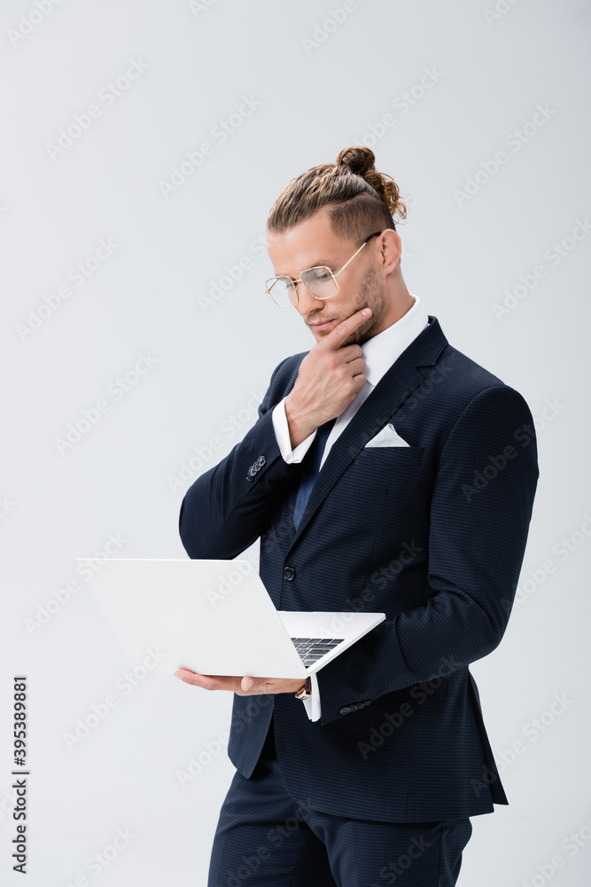 young businessman in suit and glasses with laptop isolated on white young businessman in suit and glasses with laptop isolated on white