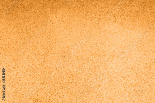 Concrete orange colorful wall surface texture. Abstract grunge bright marigold color background with aging effect. Copyspace. Trendy color of the year 2021.