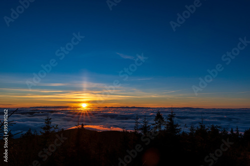 Inversion in the valley during sunrise with mountain ridge in the background, Beskydy , Czech Republic. © Martin