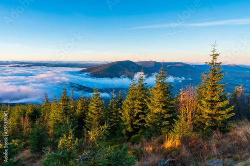 Inversion in the valley during sunrise with mountain ridge in the background, Beskydy , Czech Republic.