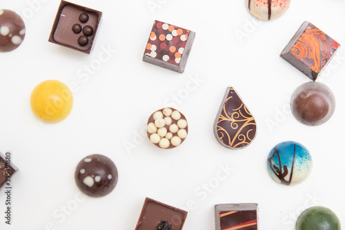 lot of variety chocolate pralines, top view of various chocolate pralines isolated on white background