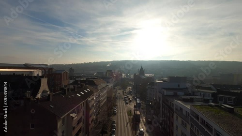Traffic into the streets of a post-industrial city, from an aerial view, during sunset