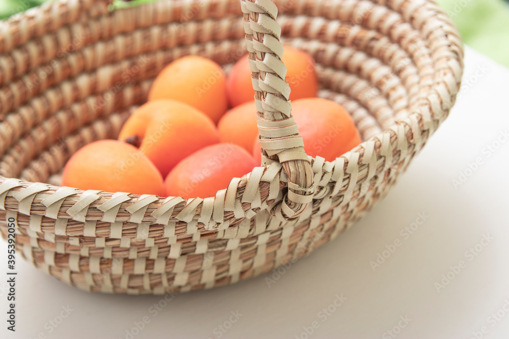 ripe apricots in plate on the table. Orange apricots fruits in bowl. Juicy apricots nutrition.