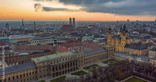 Munich, Germany Cityscape with View of Frauenkirche Cathedral and beautiful Old City Architecture with Sun setting, Aerial Hyper Lapse, Moving Time Lapse above big german City photo