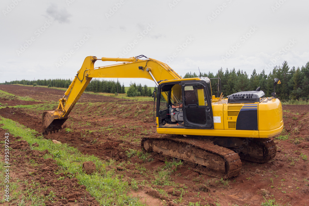 Crawler Excavator digging bucket on construction of road. Construction of a road. Earth movement Crawler Excavator digging bucket on construction of road. Construction of a road. Earth movement
