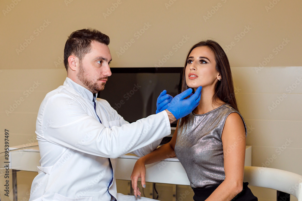 Doctor makes a markup on the face of a beautiful female before the comet procedure for correcting the shape of the face Doctor makes a markup on the face of a beautiful female before the comet procedure for correcting the shape of the face