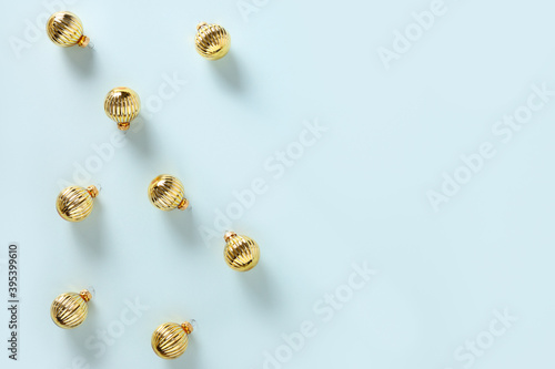 Christmas banner of golden festive balls on blue. Top view. Xmas greeting card for wishes.