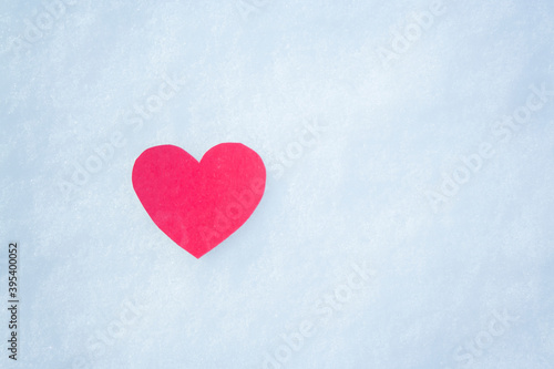 paper red heart on snow with snowflakes. Love winter. Valentine day, mother day, woman day. Copy space.