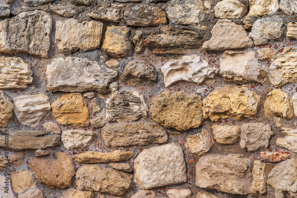 Ancient stone wall made of stones of different colors. Ancient stone wall made of stones of different colors.