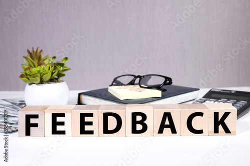 feedback, text on wooden cubes on gray background