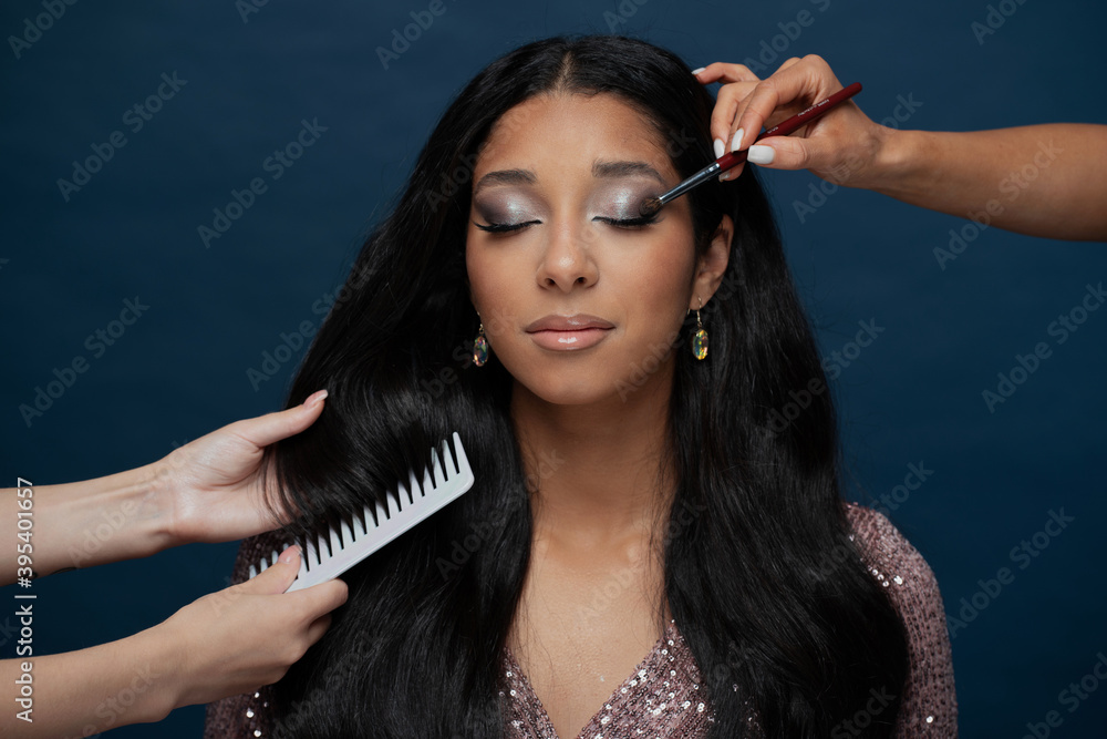 Obraz premium professional makeup bright for a holiday, a young woman of European appearance, big lips, black long smooth hair, brunette, brown eyes, large eyelashes
