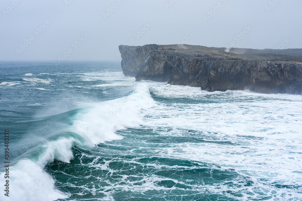 Landscape of the karst limestone sea cliffs in Asturias in the Llanes coast, North of Spain, with the waves cruhsing against the cliffs. Landscape of the karst limestone sea cliffs in Asturias in the Llanes coast, North of Spain, with the waves cruhsing against the cliffs.