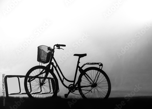 Back lit silhouette of bike in bicycle stand