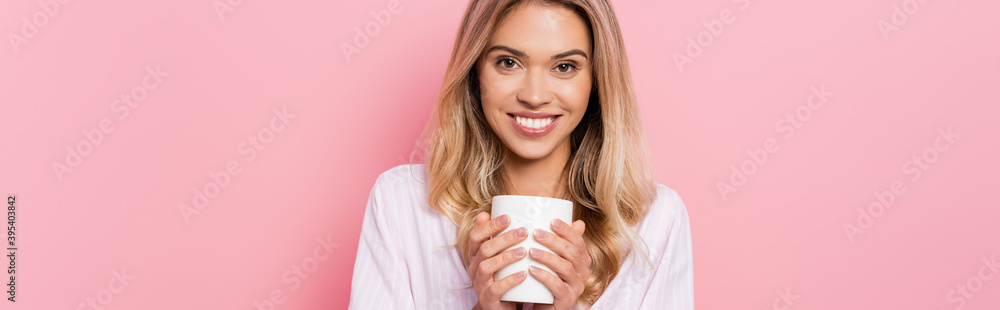 woman in pajamas holding cup on pink background, banner woman in pajamas holding cup on pink background, banner