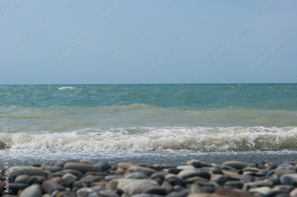 The Sea Wave of the Black Sea is a pebble beach. Smooth horizon, blue sky. Vacation vacation vacation summer happiness appeasement