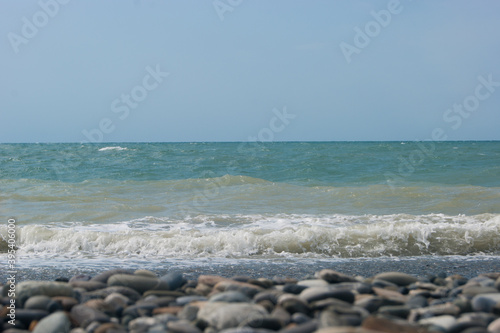 The Sea Wave of the Black Sea is a pebble beach. Smooth horizon, blue sky. Vacation vacation vacation summer happiness appeasement