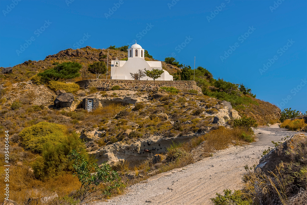 A view of a church from the path on the Caldera rim in Santorini in summertime