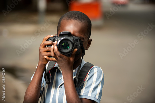 beautiful little boy holding a camera © vystekimages