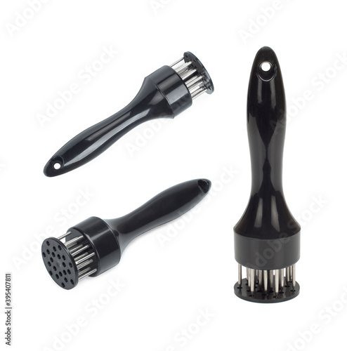 A hand-powered meat tenderizer for puncture the meat and cut into the fibers of the muscle on a white background photo