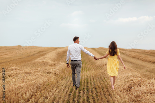 Happy young couple on straw, romantic people concept, beautiful landscape, summer season