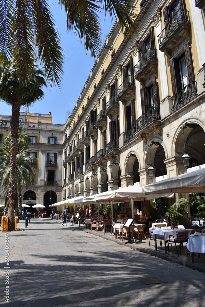 Square with palm trees and cafe