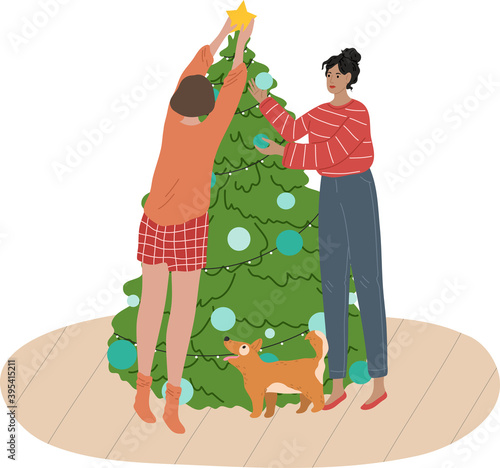 Girls friends roommates or sisters decorating Christmas tree with toys