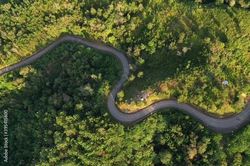 Aerial view of hilly region showing forests, roads and slopes.