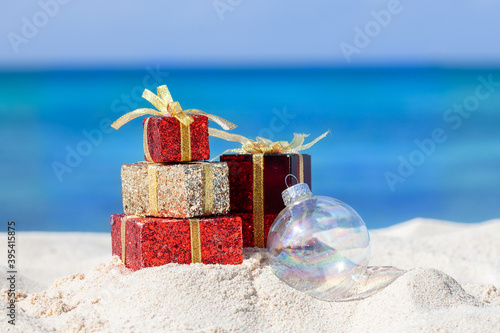 Christmas presents and ornament on the beach.