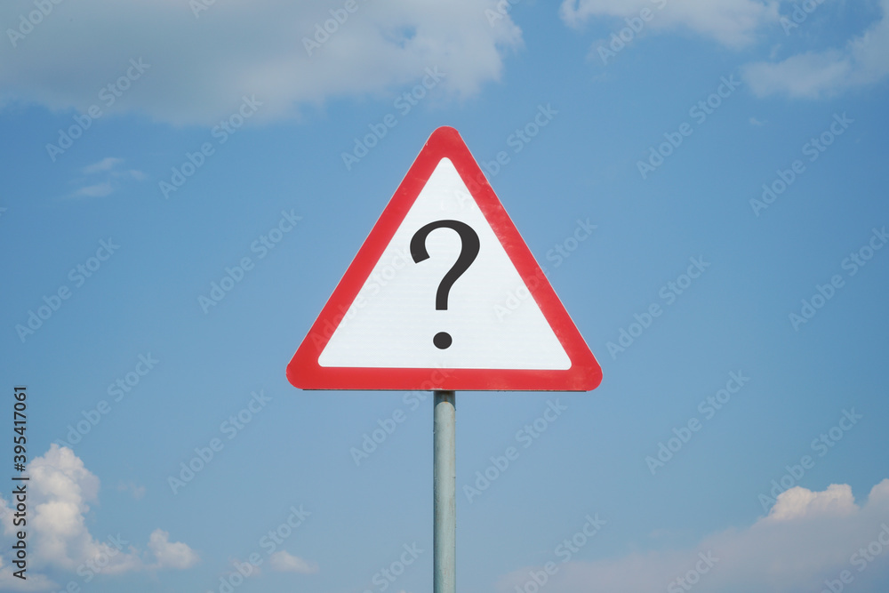 Warning road sign with question mark on a background of blue sky with clouds. Creative idea, what's next, ask