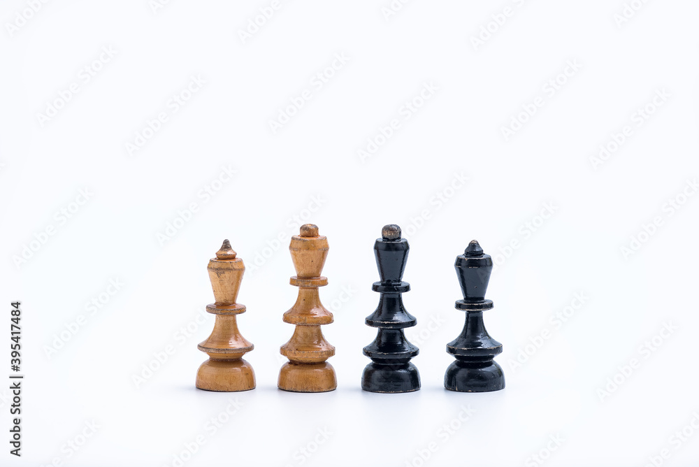 Old Chess Set - Kigns and Queens pieces on a white background with copy space