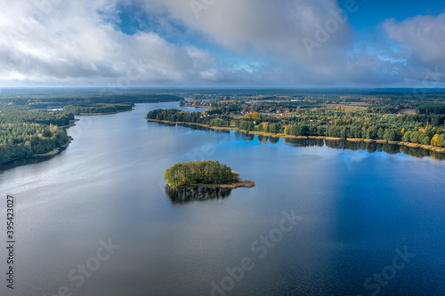 Fototapeta Naklejka Na Ścianę i Meble -  Aerial view of Omulew lake under blue cloudy sky