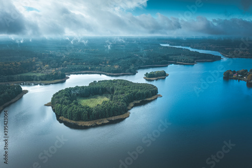 Fototapeta Naklejka Na Ścianę i Meble -  Aerial view of Omulew lake under blue cloudy sky