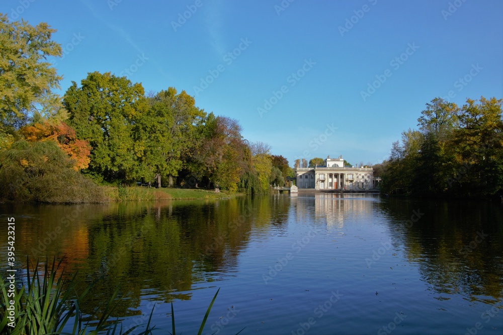 Autumn time in Warsaw's Royal Baths Park (in Polish: Lazienki Krolewskie). Palace on the Water and pond with reflections in the water. Warsaw, Poland Autumn time in Warsaw's Royal Baths Park (in Polish: Lazienki Krolewskie). Palace on the Water and pond with reflections in the water. Warsaw, Poland
