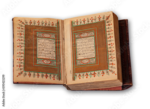 Old arabic holy Quran also romanized Qur'an or Koran, is the central religious text of Islam. Antique book  with hand coloring in gold. Image showing two pages opened up in a spread.