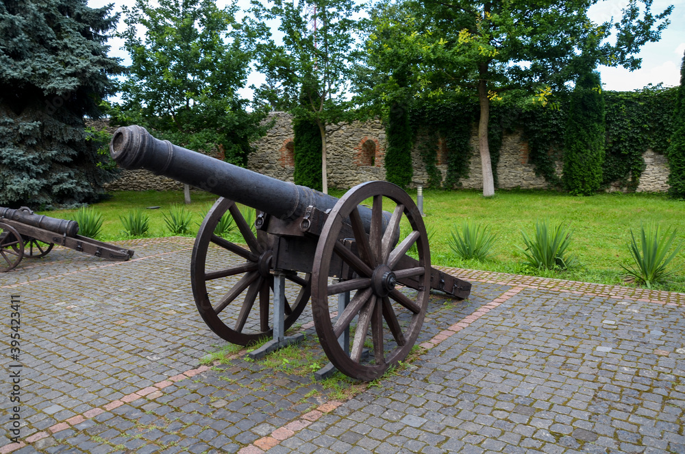 Old historic cannon on wooden wheels, stands in the courtyard of Dubno castle, Rivne region, Ukraine. 