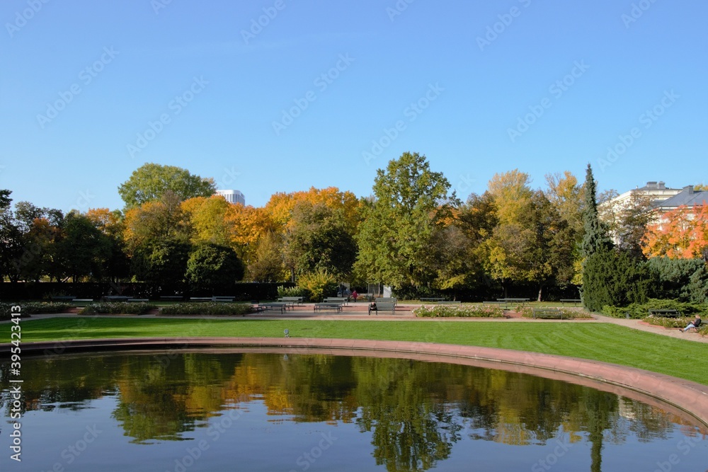 Beautiful warm autumn day at Mokotow Field (Polish: Pole Mokotowskie) - a large park complex with artificial pond. Warsaw, Poland, Europe