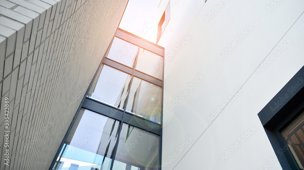 Modern apartment buildings on a sunny day with a blue sky. Facade of a modern apartment building. Glass surface with sunlight. Modern apartment buildings on a sunny day with a blue sky. Facade of a modern apartment building. Glass surface with sunlight.