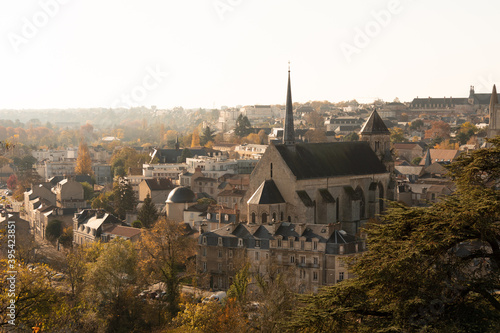 Cityscape of Poitiers, France. View on the roof. There is a church. Light coming from the right. Photographed in autumn, on a sunny day. © Adrien