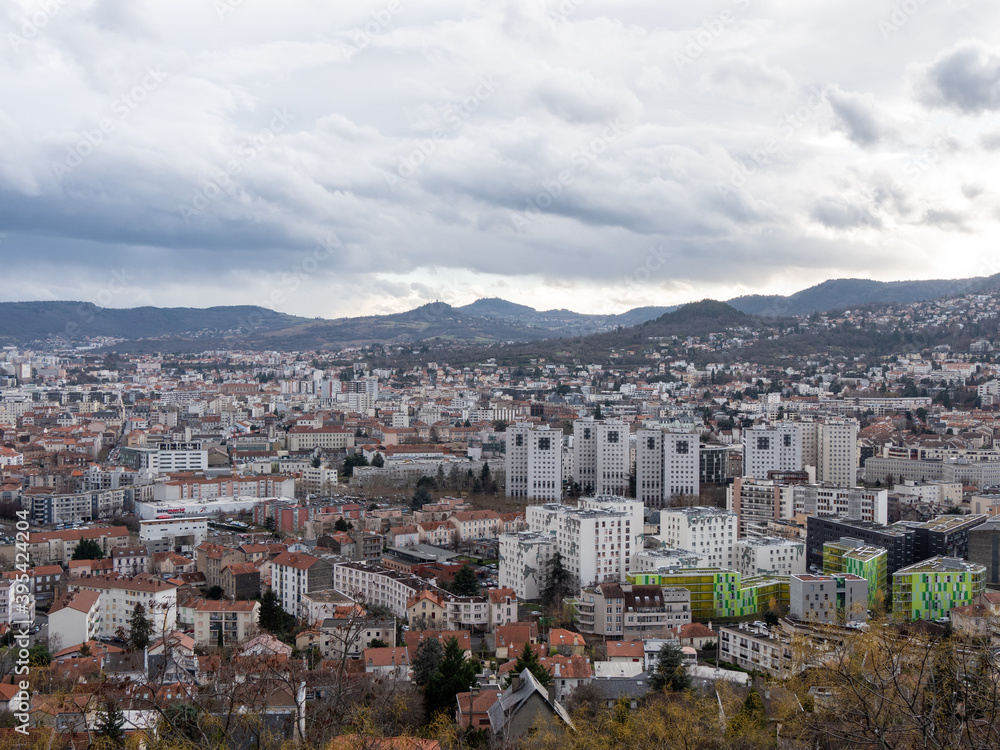 Cityscape of Clermont-Ferrand, a city and commune of France, in the Auvergne-Rhône-Alpes region. Cloudy sky.