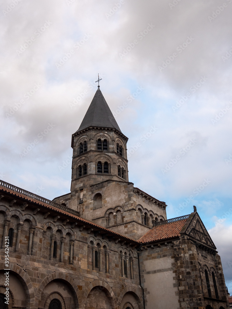 Tower of Basilica of Notre-Dame du Port in Clermont-Ferrand, a french city located in Auvergne region. Black stones.