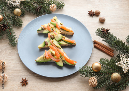 Funny sandwich in shape of Christmas tree with avocado  salmon and cheese for kids