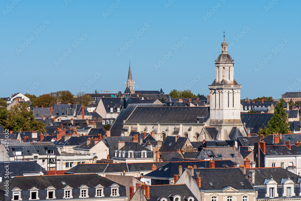 Naklejka premium View on the roofs of the city of Angers. There is a church bell tower. Angers is located in western France. Sunny day and blue sky.