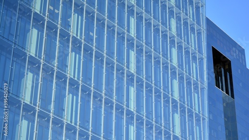 Facade texture of a glass mirrored office building. Fragment of the facade. Modern architecture of the office building.